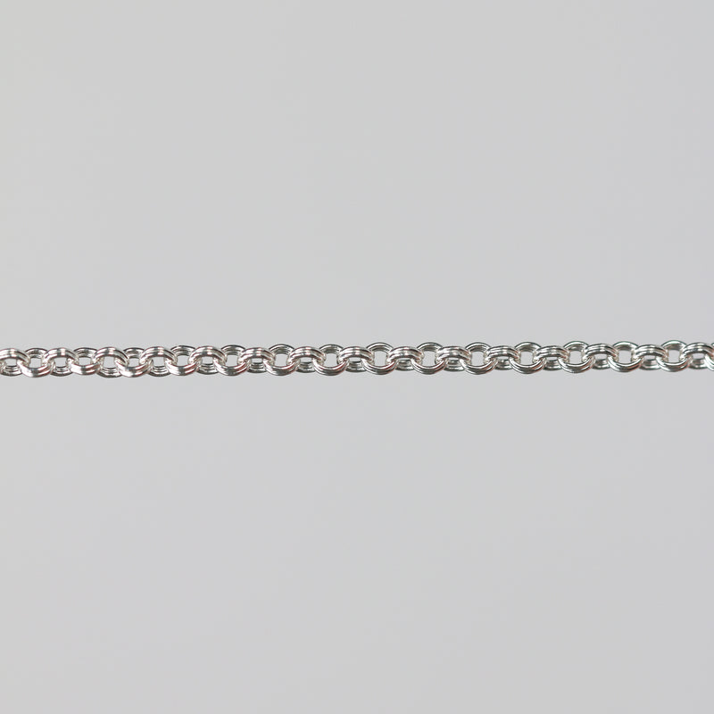 Silver double cable chain on a gray background