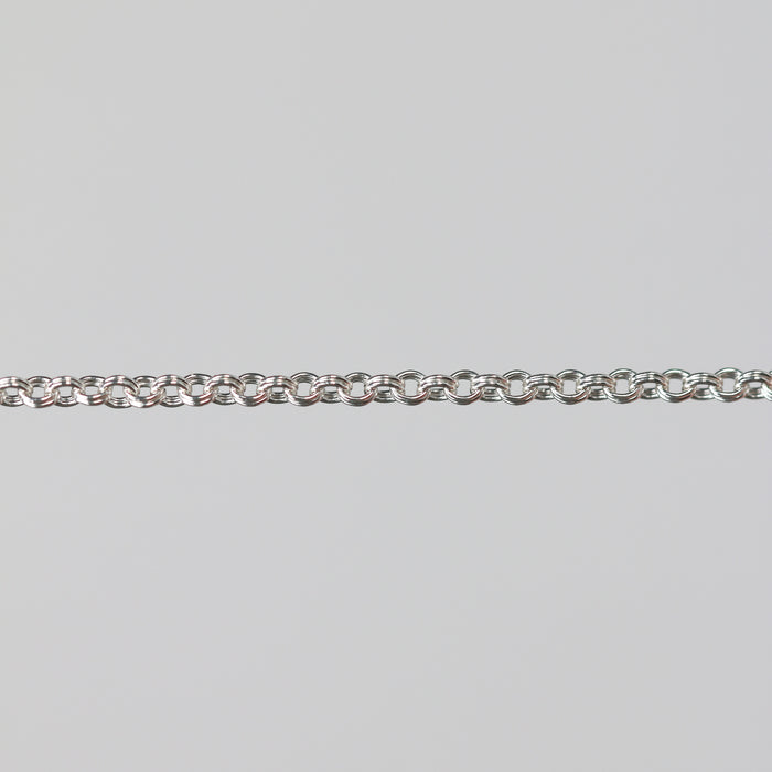 Silver double cable chain on a gray background