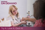 Person receiving a permanent jewelry bracelet from a rented pj welder with sunstone ON DEMAND branding in the corner.