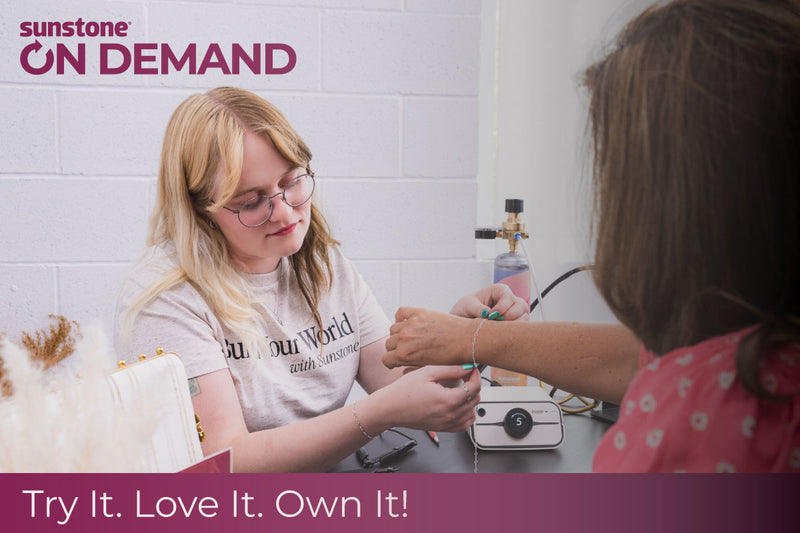 Person receiving a permanent jewelry bracelet from a rented pj welder with sunstone ON DEMAND branding in the corner.