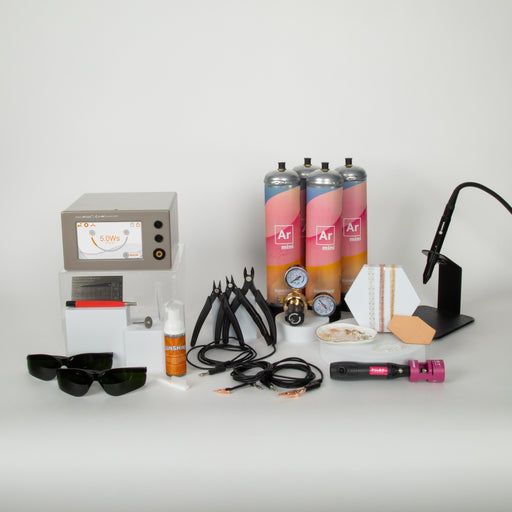 Everything you need to start a permanent jewelry business laid out with a white background. Pictured is welding equipment, safety glasses, argon gas, and other accessories and supplies