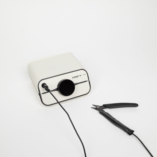 White and black zapp plus 2 welder with black pliers grounded to it