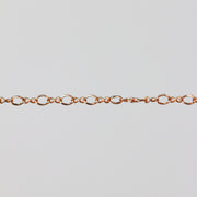 Rose gold chain pulled taut to show the links of the chain