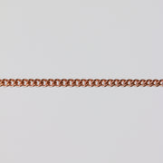 Rose gold curb chain for permanent jewelry on a light gray background