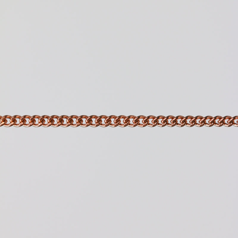 Rose gold curb chain for permanent jewelry on a light gray background