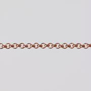 Rolo chain in gold filled rose stretched over a gray background to show the links
