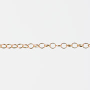 Gold filled yellow chain with round links on a white background