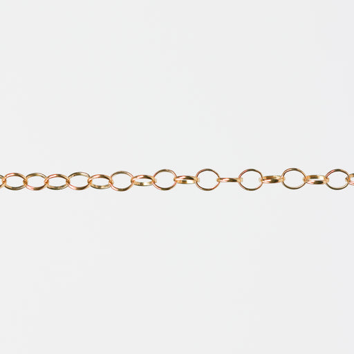 Gold filled yellow chain with round links on a white background