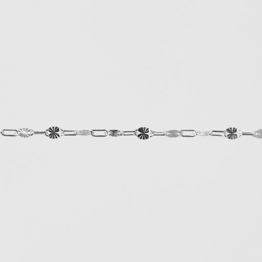 Silver bracelet with decorative links on a light gray background