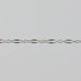 Closeup of a silver chain that has elongated links that are dapped and regular round links.
