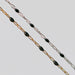 Two gold and silver chains for permanent jewelry with black enamel on a light gray background