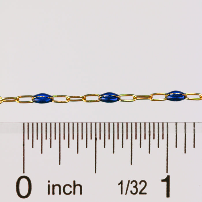 Gold and blue pj chain getting measured with a ruler and showing scale on a white background