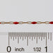 Gold and red chain with a ruler for scale on a white background
