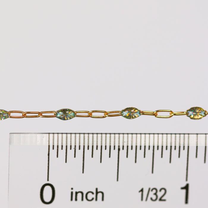 Gold Chain with enamel on it laying above a ruler for measurement