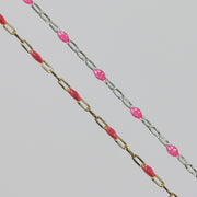 Two cable chains side by side with pink enamel on them