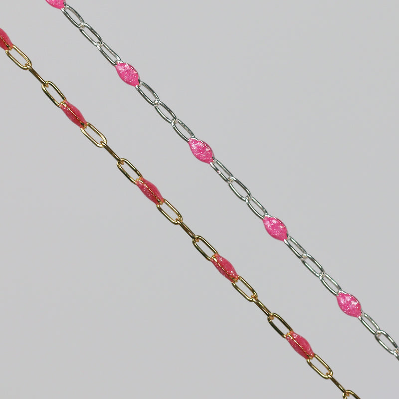 Two cable chains side by side with pink enamel on them
