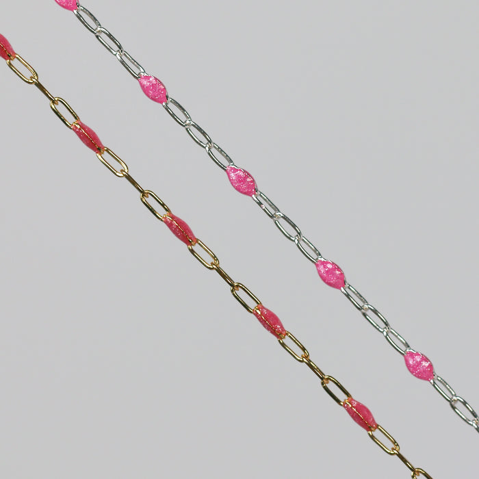 Two cable chains side by side with pink enamel on them