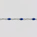 Silver cable chain for permanent jewelry with blue enamel on a light gray background