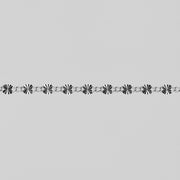 Decorative sterling silver chain pattern on a gray background