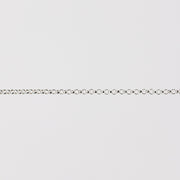 Silver chain bracelet on a light gray background