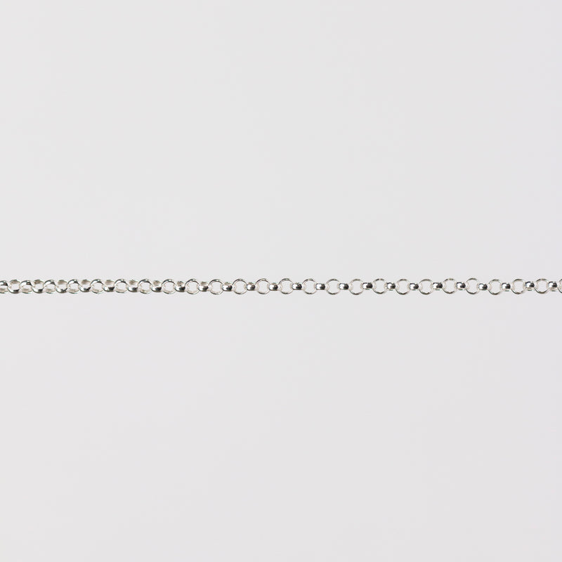Silver chain bracelet on a light gray background