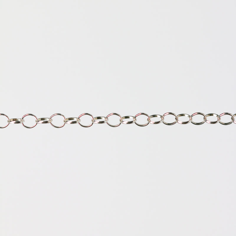 Silver chain for permanent jewelry making on a gray background