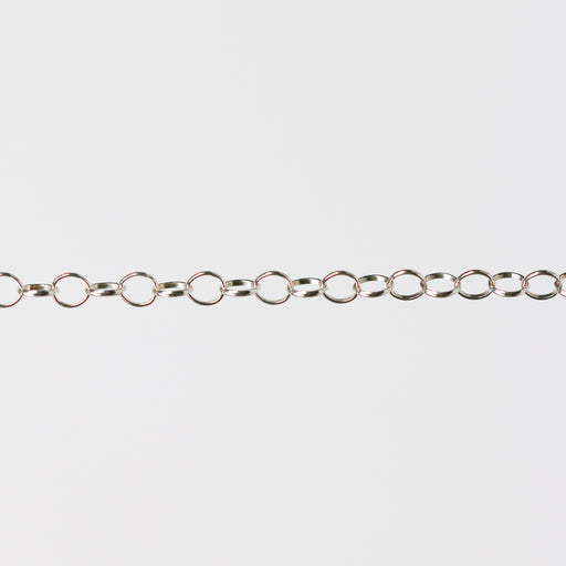 Silver chain for permanent jewelry making on a gray background