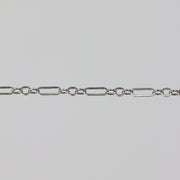 Sterling silver permanent jewelry chain on a gray background