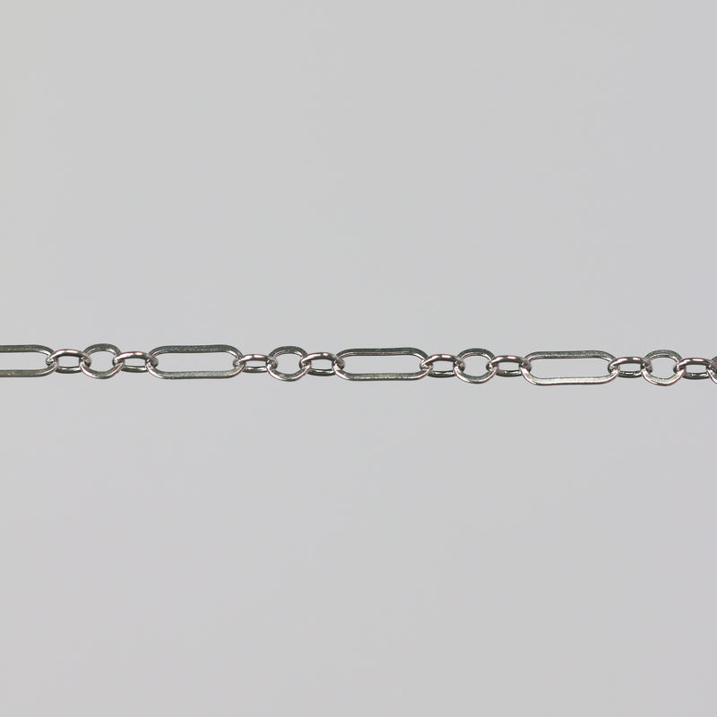 Sterling silver permanent jewelry chain on a gray background