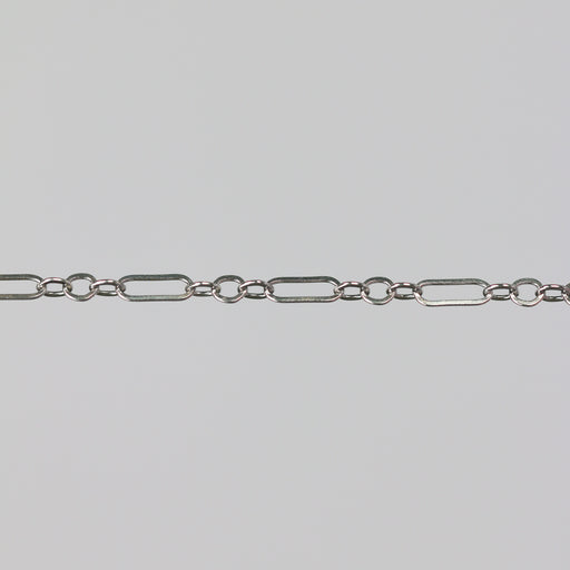 Sterling silver permanent jewelry chain on a gray background