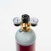 Small pressure regulator on a small argon gas cylinder with a white background