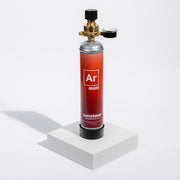 Sunstone Argon mini gas canister standing on a white pedestal with a mini gas regulator attached to it on a white background