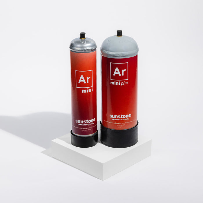 Two red cylindrical gas tanks with 'Ar' (Argon) Sunstone PJ branding on a white background