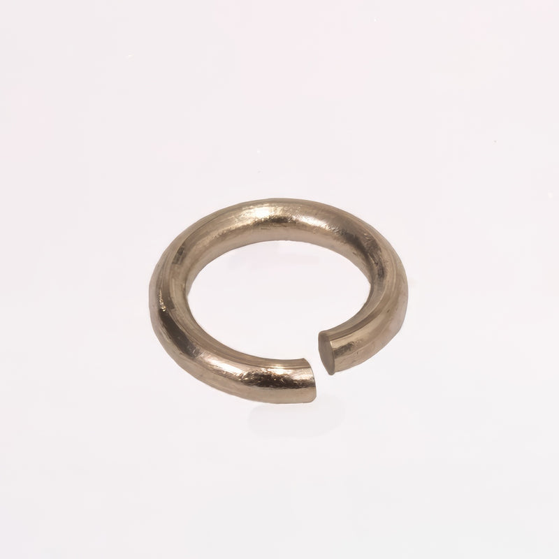A jump ring that's 14k white gold shown up close, photographed on a plain white background.
