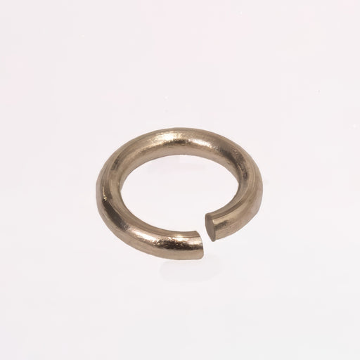 A jump ring that's 14k white gold shown up close, photographed on a plain white background.