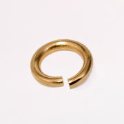 A gold filled yellow metal jump ring, photographed on a clean white background.