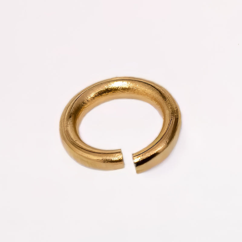 A gold filled yellow metal jump ring, photographed on a clean white background.