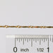 The Brittany chain in gold shown up close next to a ruler showcasing the size of the links and dapped bar design.