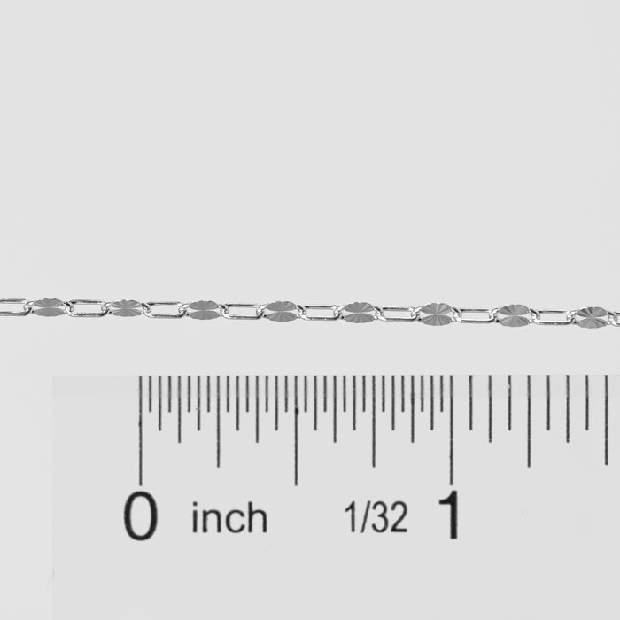Silver chain with a ruler for scale on a white background