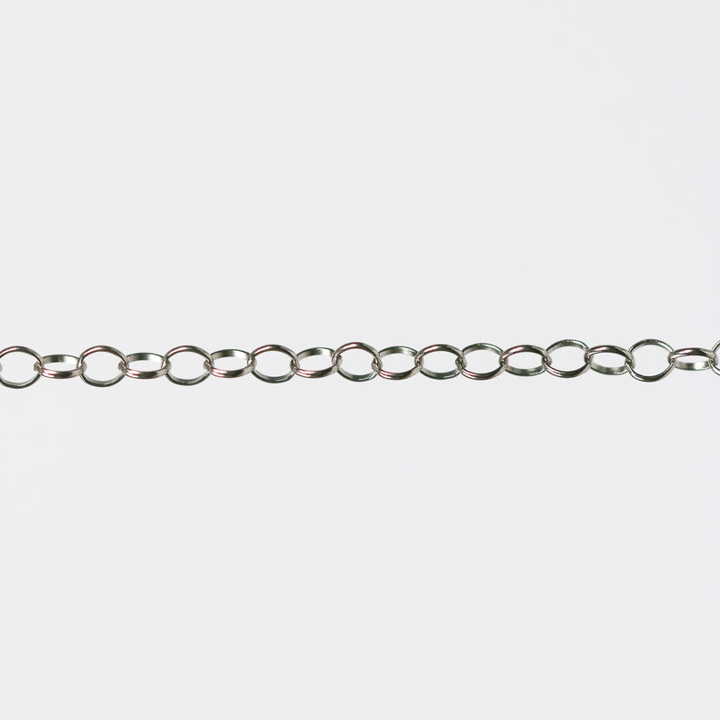 Round permanent jewelry chain on a light gray background