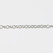 Round permanent jewelry chain on a light gray background