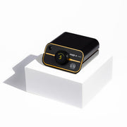 Black and gold zapp plus 2 welder on a white platform with a white background