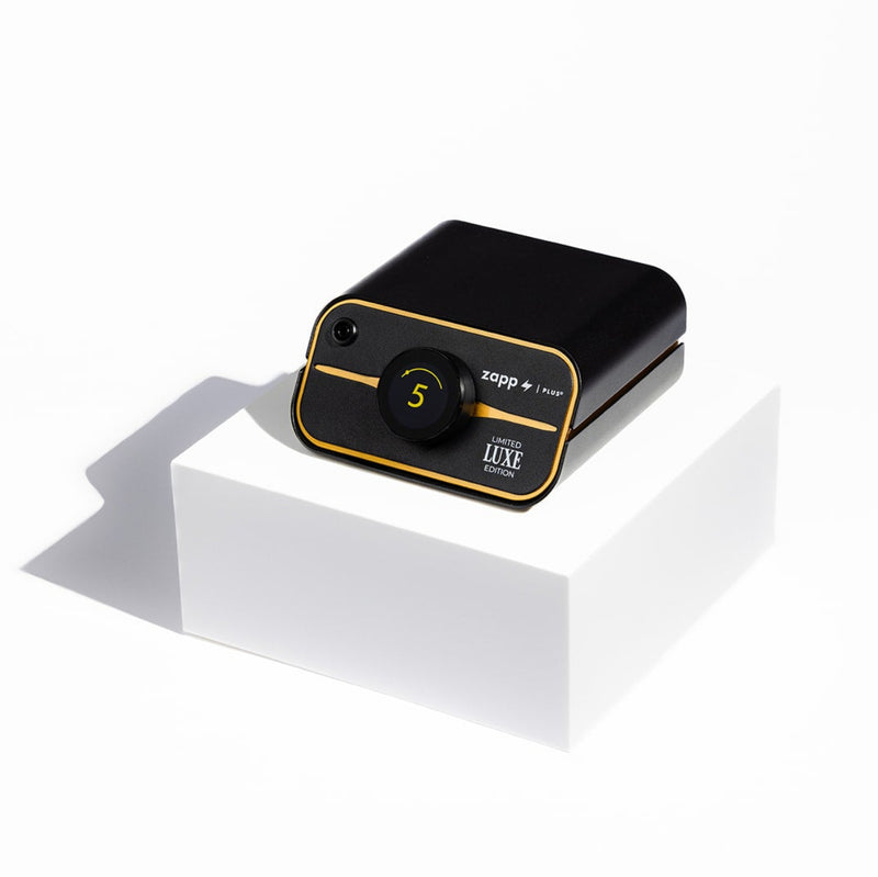 Black and gold zapp plus 2 welder on a white platform with a white background