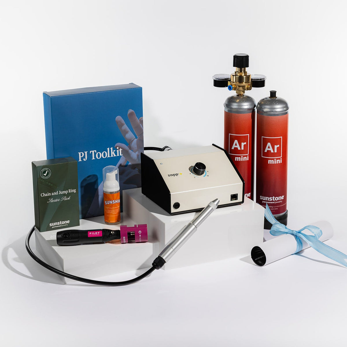 Photo of the Zapp® Permanent Jewelry Welder on a Small White Pedestal