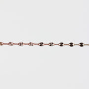 Rose gold bracelet on a light gray background