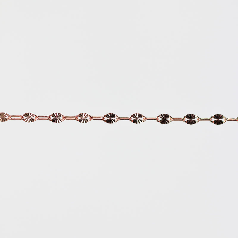 Rose gold bracelet on a light gray background