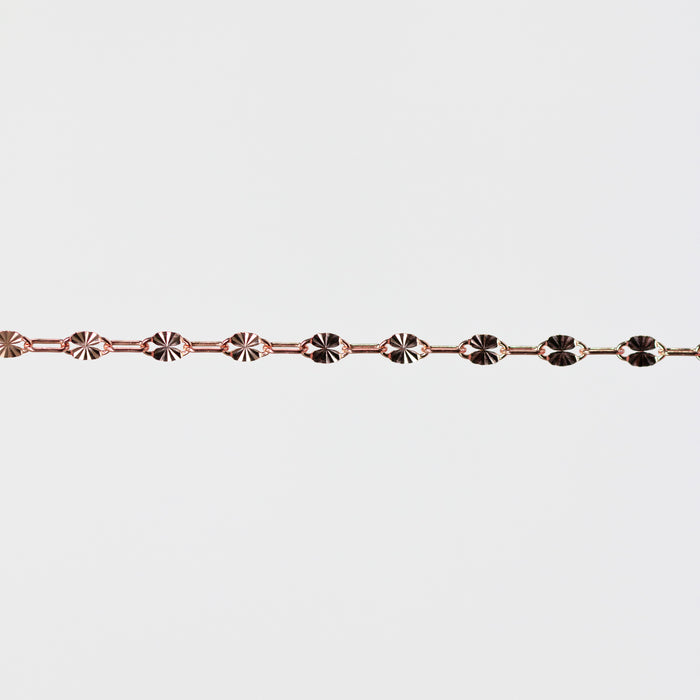 Rose gold bracelet on a light gray background